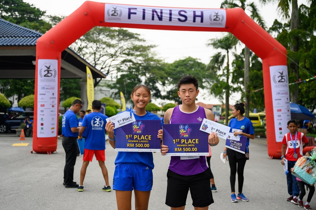 Two winners with prizes at the finish line