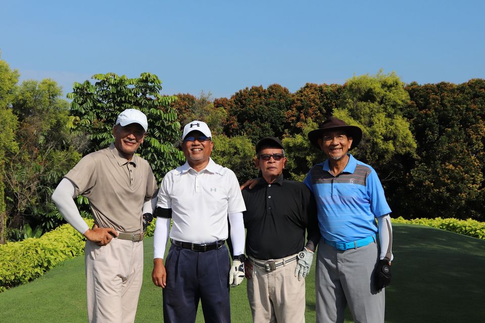 Group of men standing together on golf course