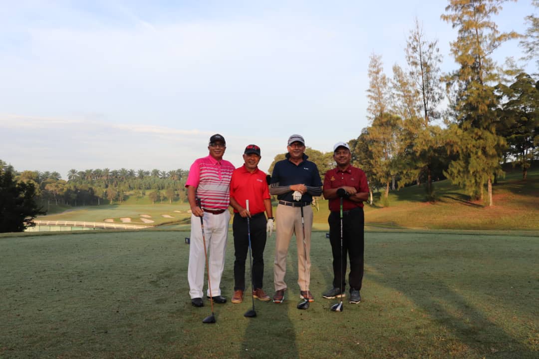 Four happy male golfers enjoying their game