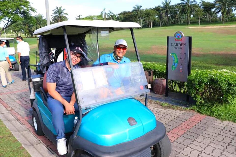 Participants travelling in a Golf Cart at the Members and Guests Medal 2021