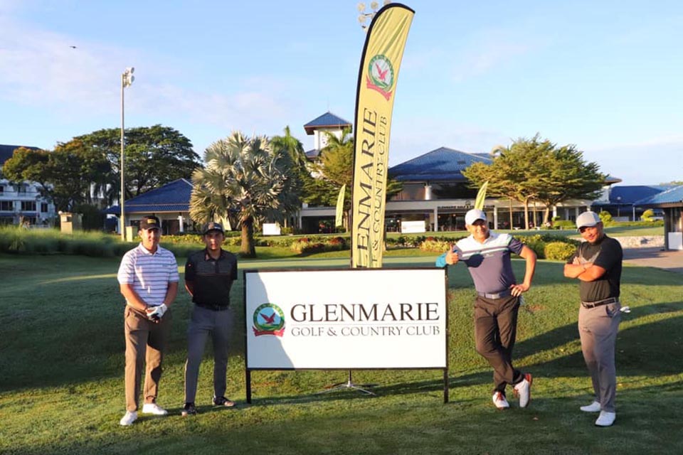 Four men standing in front of the Glenmarie Board