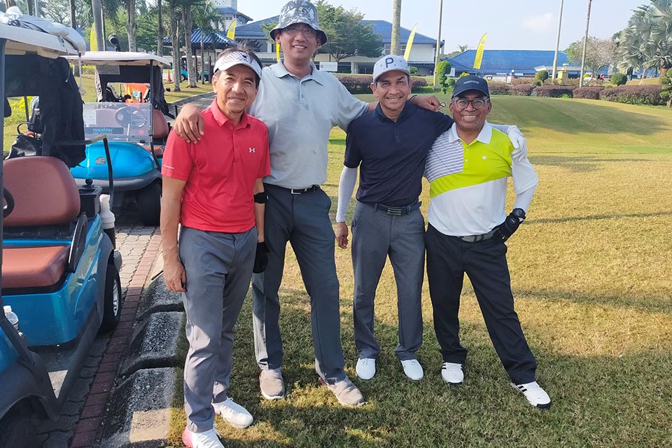 Four golfers are posing for a picture at Glenmarie