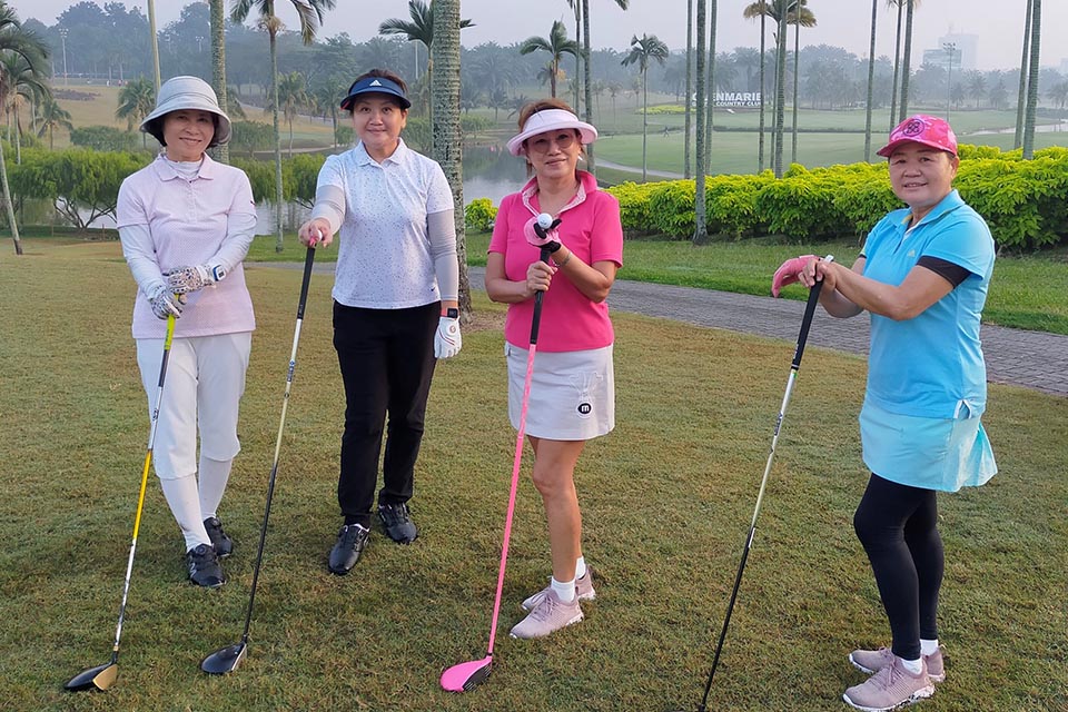 Four lady golfers are posing for a picture at Glenmarie