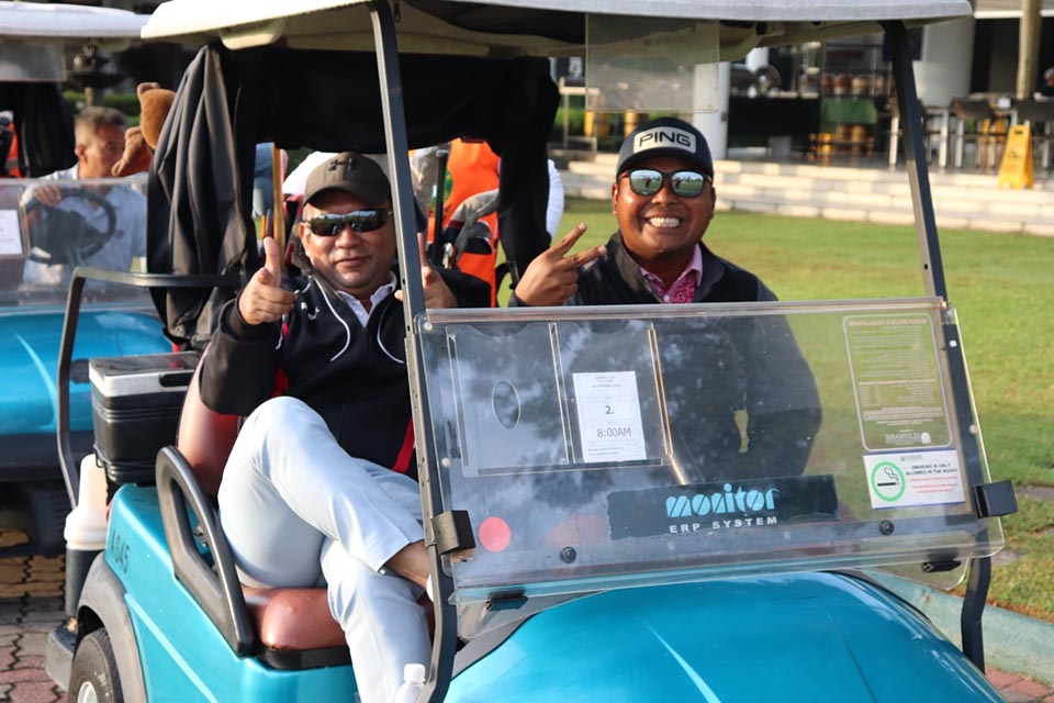 Two guests enjoying a golf cart ride at Glenmarie