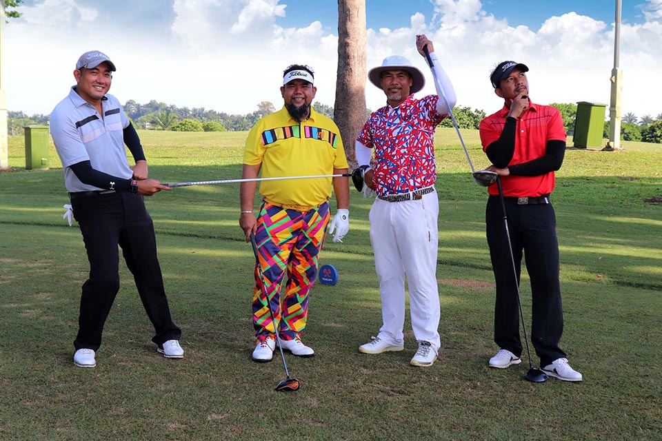 Four golf players are posing for a photograph
