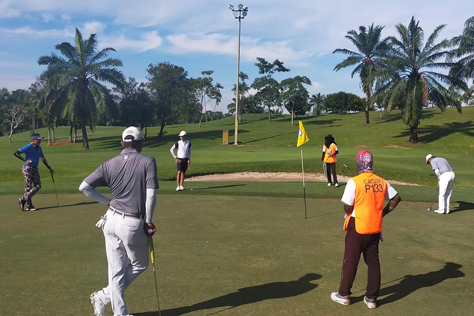 A group of players playing round of Golf